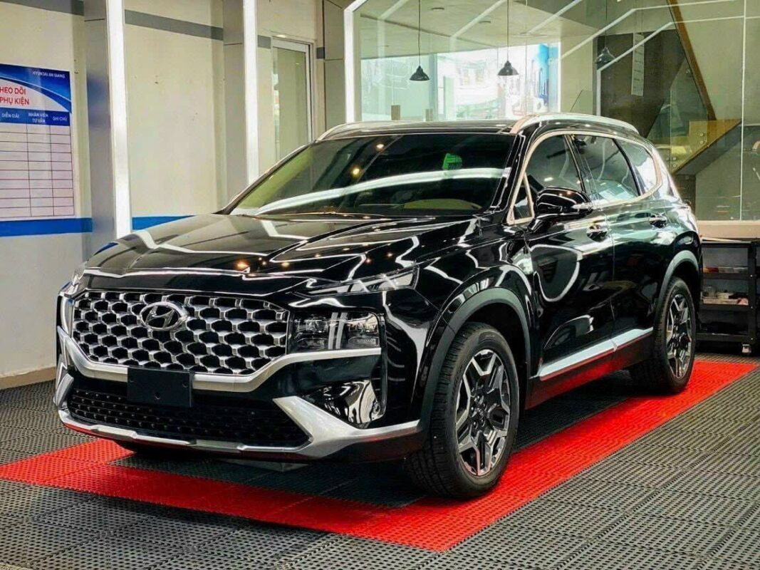 a black suv parked in a showroom